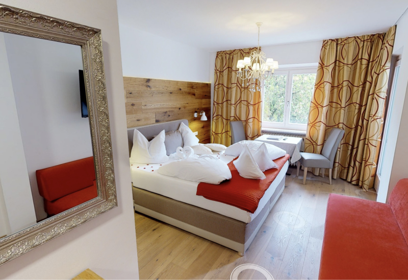 Hotel room with large bed and curtains