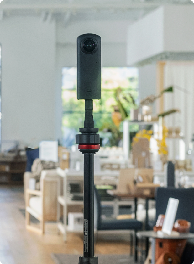 A 360 Camera on a tripod in a modern office