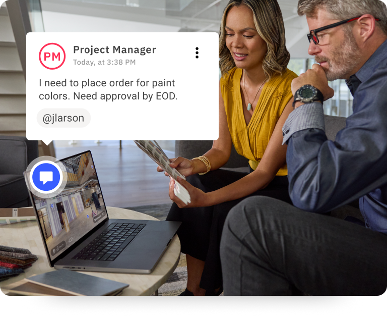 Two people working on a computer together